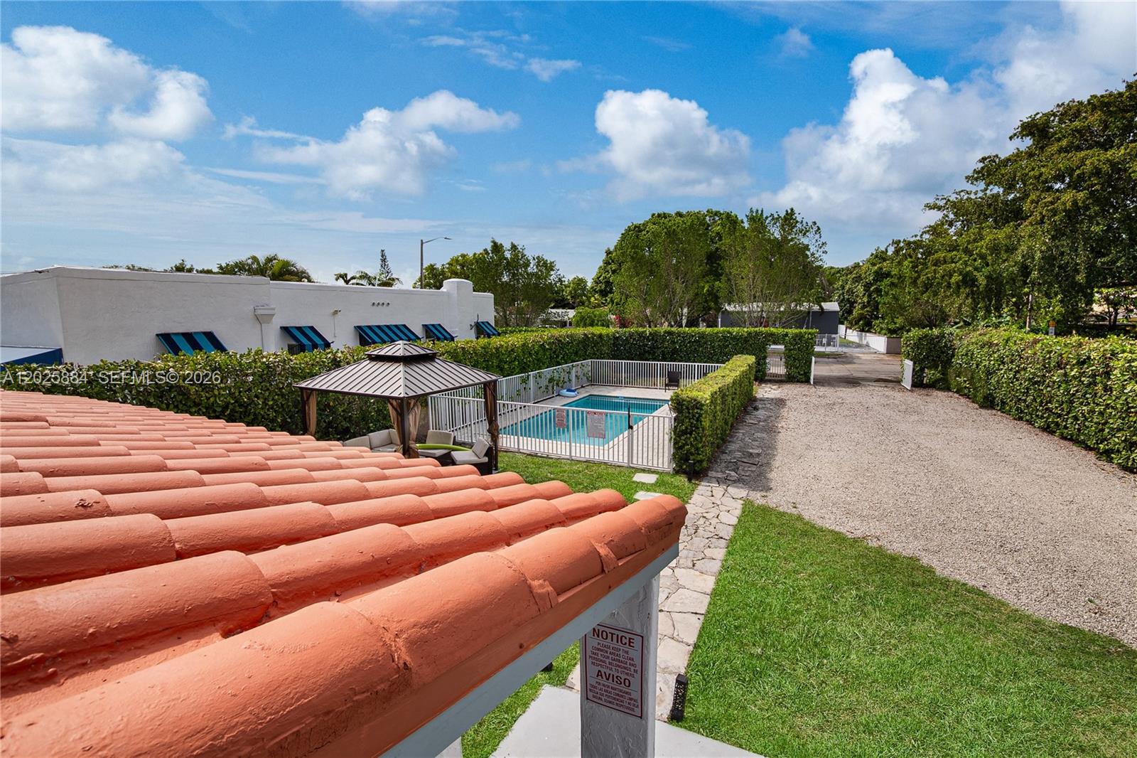 An elevated view shows a tiled roof overlooking a swimming pool, gazebo, and gravel driveway — 2255 SW 10th St # B, Miami FL 33135, MIAMI, FL