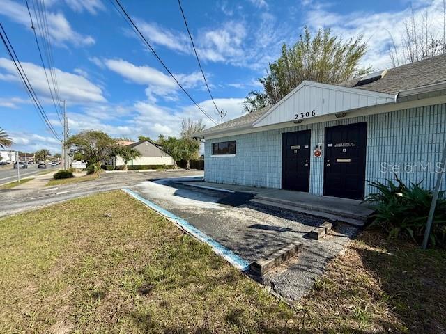 A single-story building with a light blue exterior and two black doors — 2306 LEE ROAD, WINTER PARK, FL