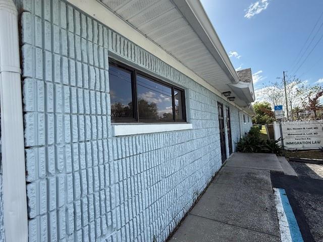 A side view of a light blue brick building with a window and a sidewalk — 2306 LEE ROAD, WINTER PARK, FL