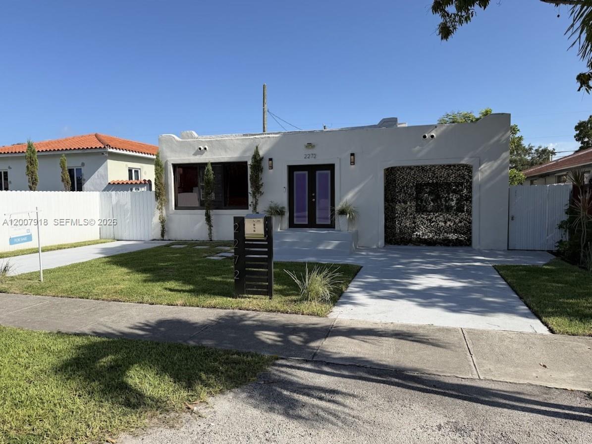 A single-story white house with a flat roof, a front lawn, and a driveway — 2272 SW 13th St, Miami FL 33145, MIAMI, FL