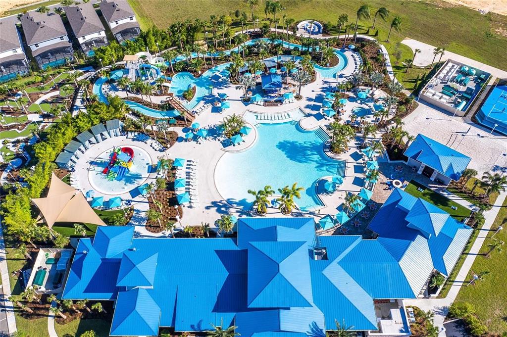 An aerial view of a resort-style swimming pool complex with water slides and surrounding buildings — 3373 LILAC WAY, DAVENPORT, FL