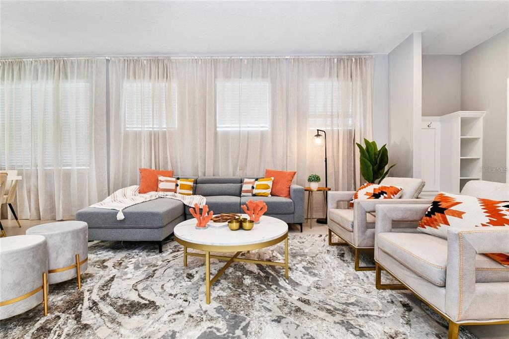 A living room features a grey sectional sofa, two armchairs, and a marble coffee table — 3373 LILAC WAY, DAVENPORT, FL