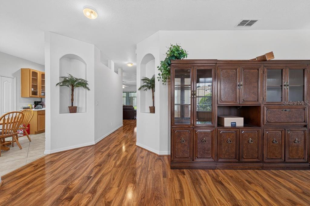 A dining area with wood-look flooring features two arched wall niches and a large hutch — 3614 PLYMOUTH DRIVE, WINTER HAVEN, FL