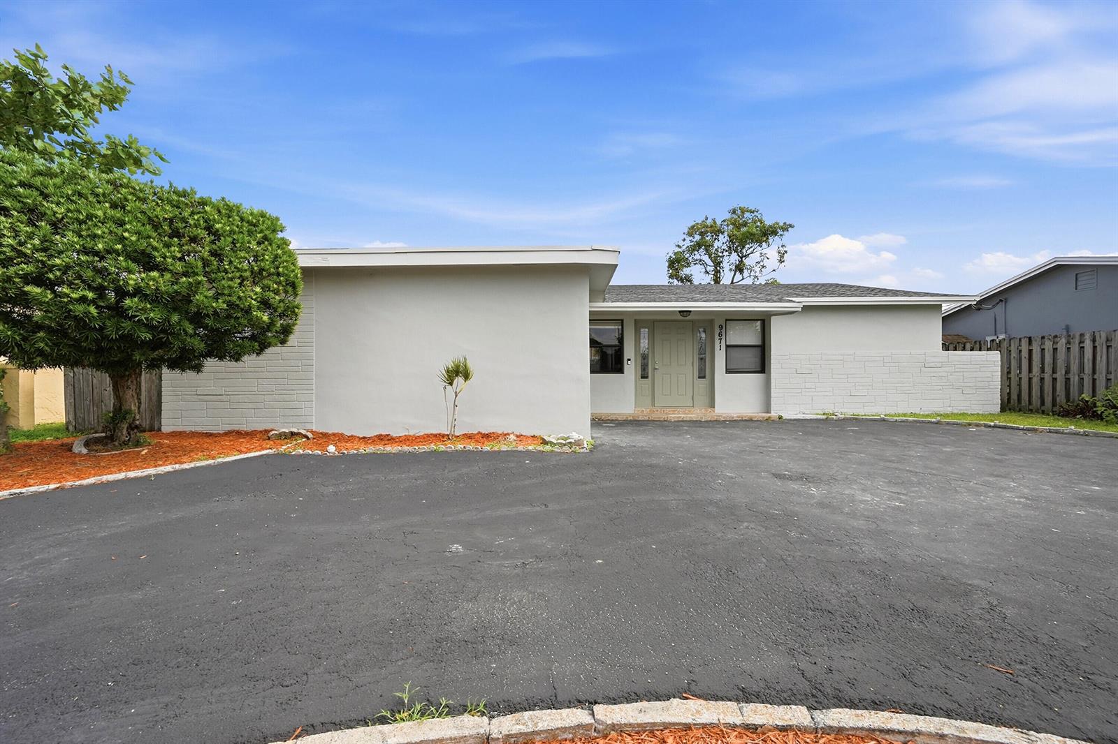 A kitchen with white cabinets, stainless steel appliances, marble-look backsplash, and a large window — 9671 NW 24th Street, Sunrise FL 33322, SUNRISE, FL
