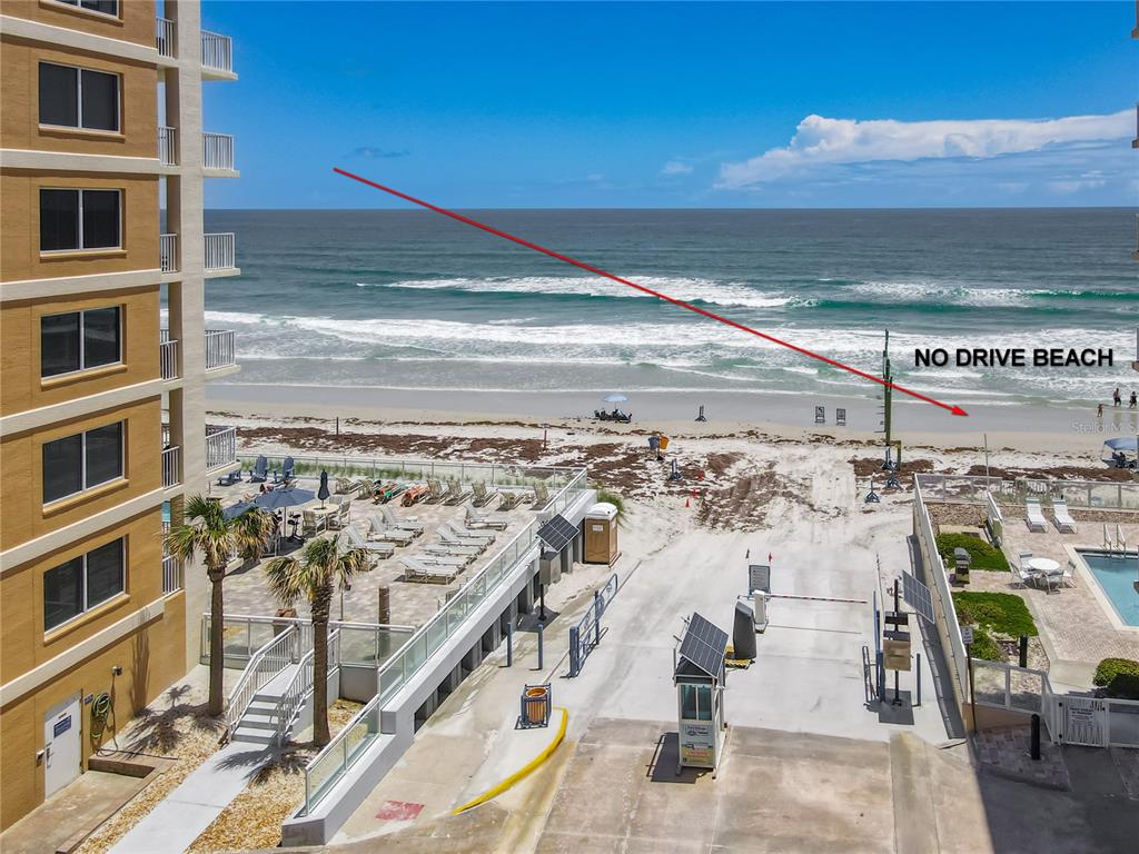 An elevated view of a beachside condominium complex with a pool and ocean access — 3799 S ATLANTIC AVENUE UNIT 1001, DAYTONA BEACH, FL