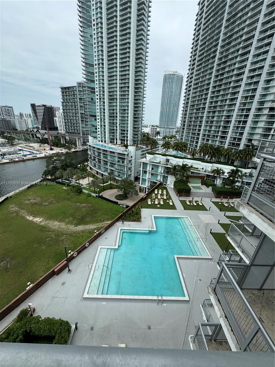 An elevated view shows a swimming pool, green space, and surrounding high-rise apartment buildings — 350 S Miami Ave # 1704, Miami FL 33130, MIAMI, FL