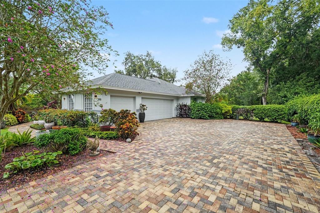 A paved driveway leads to a two-car garage in front of a single-story house — 2950 ST ANDREWS BOULEVARD, TARPON SPRINGS, FL