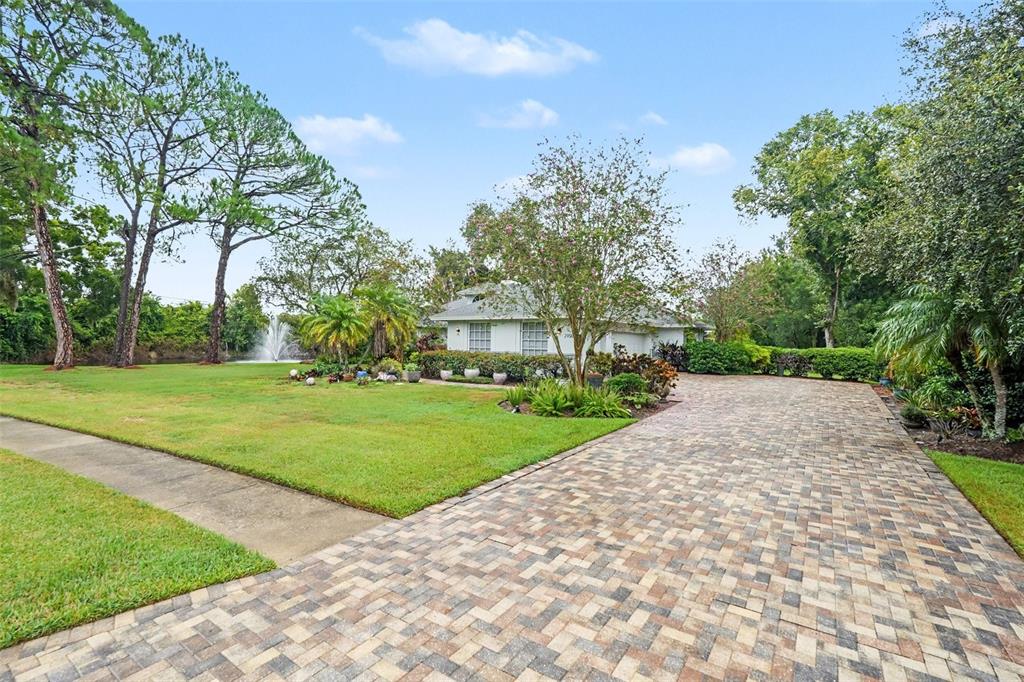 A view of a golf course green with a red flag and surrounding trees — 2950 ST ANDREWS BOULEVARD, TARPON SPRINGS, FL