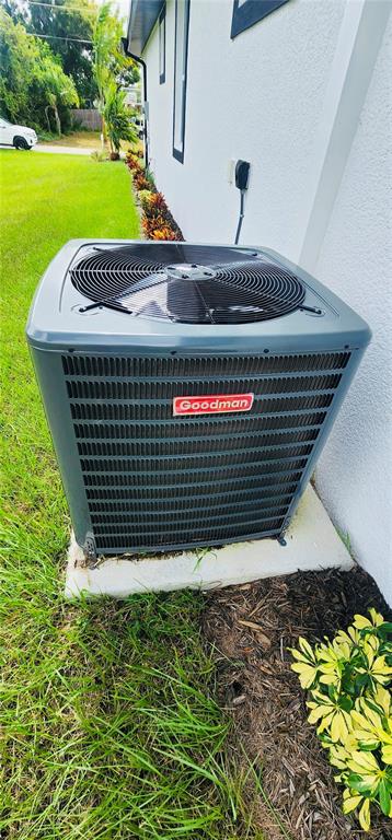 A Goodman air conditioning unit sits on a concrete pad next to a house exterior — 5555 VERACRUZ TERRACE, PORT CHARLOTTE, FL