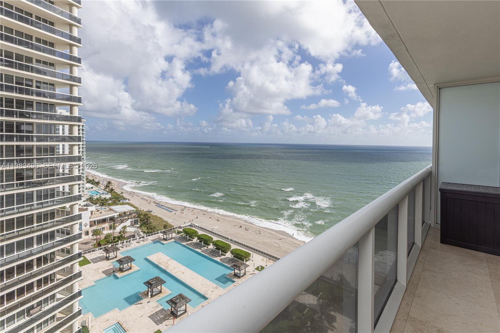 A high-rise balcony overlooks a swimming pool, sandy beach, and the ocean — 1830 S Ocean Dr # 2108, Hallandale Beach FL 33009, HALLANDALE BEACH, FL