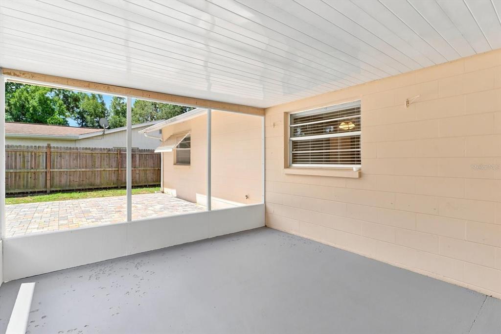 A screened-in porch with a gray painted floor, light-colored block walls, and a white ceiling — 1285 N HAGGERTY POINT, CRYSTAL RIVER, FL