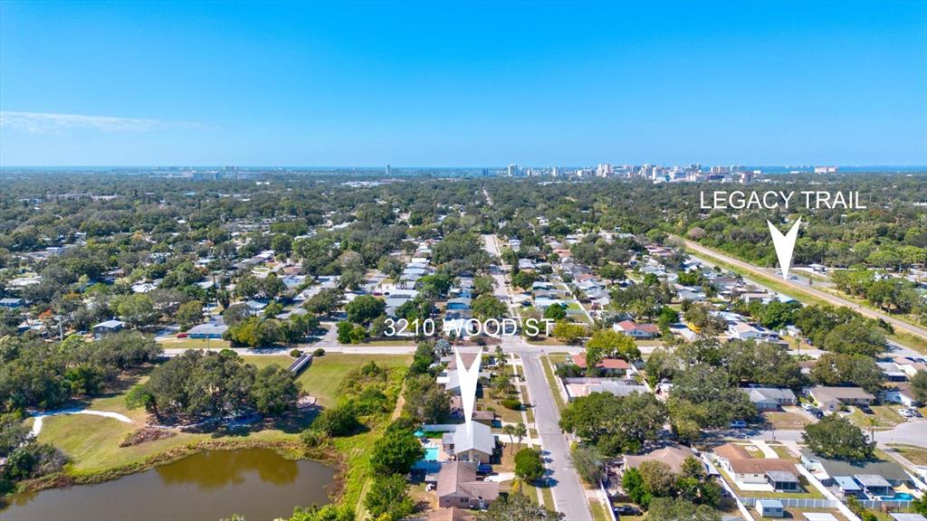 An aerial view shows a residential neighborhood with a nearby trail and a small pond — 3210 WOOD STREET, SARASOTA, FL