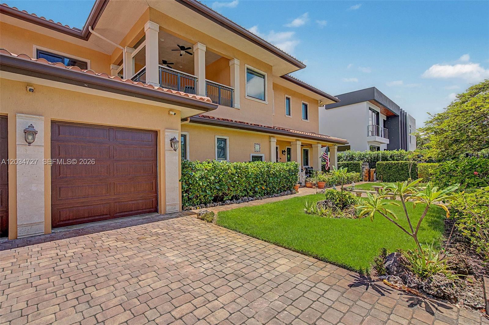 A two-story house with a tan stucco exterior, a brown garage door, and a paved driveway — 4251 SW 11th St, Miami FL 33134, MIAMI, FL