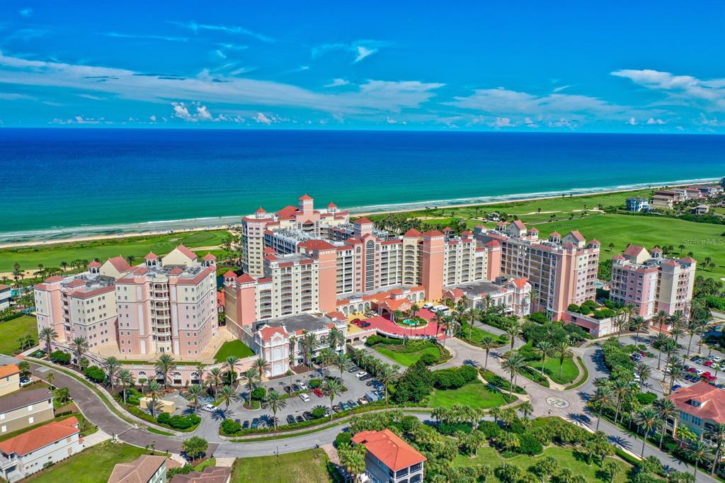 An aerial view of a large resort hotel complex situated along a sandy beach and ocean — 200 OCEAN CREST DRIVE UNIT 1018, PALM COAST, FL