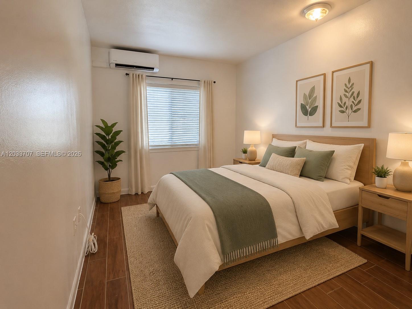 A bedroom features a wooden bed frame, green accents, a window, and wood-look flooring — 2500 Sunshine Blvd, Miramar FL 33023, MIRAMAR, FL