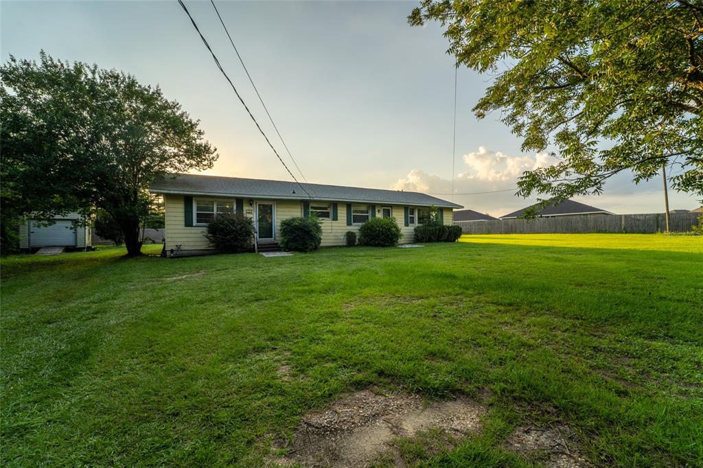 A single-story yellow house with a large grassy yard and a detached shed — 6915 KLONDIKE ROAD, PENSACOLA, FL