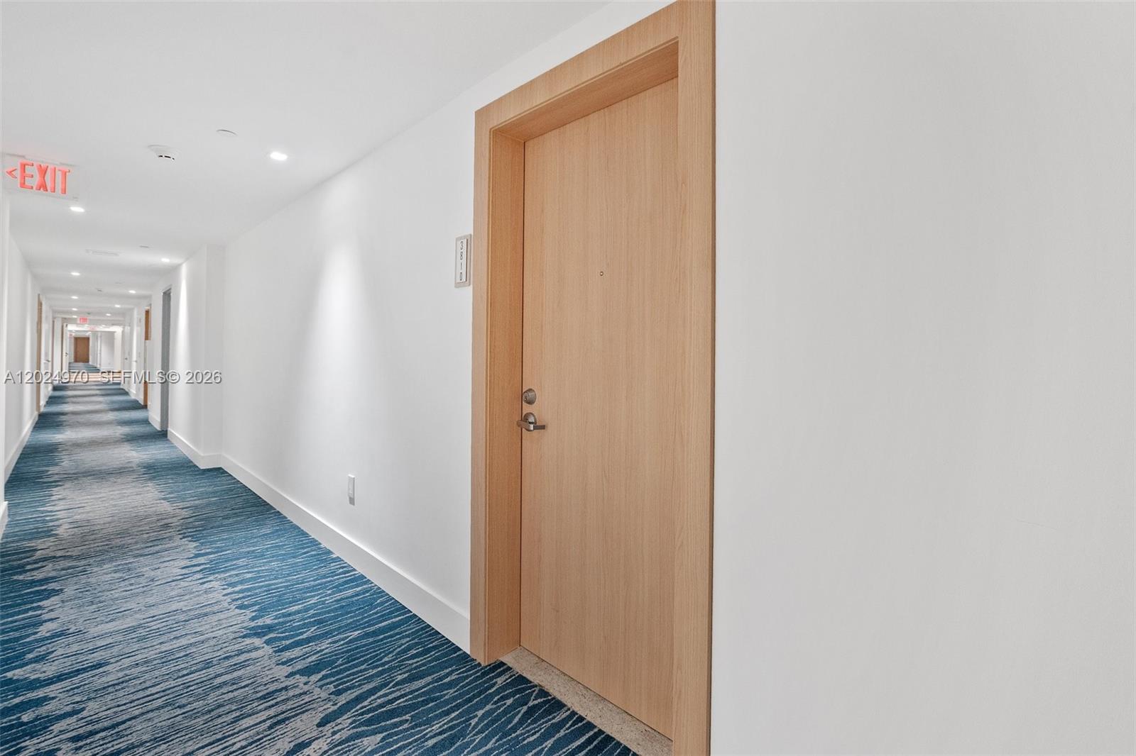 A light wood door with a silver handle is set in a white hallway — 90 SW 3rd St # 3810, Miami FL 33130, MIAMI, FL