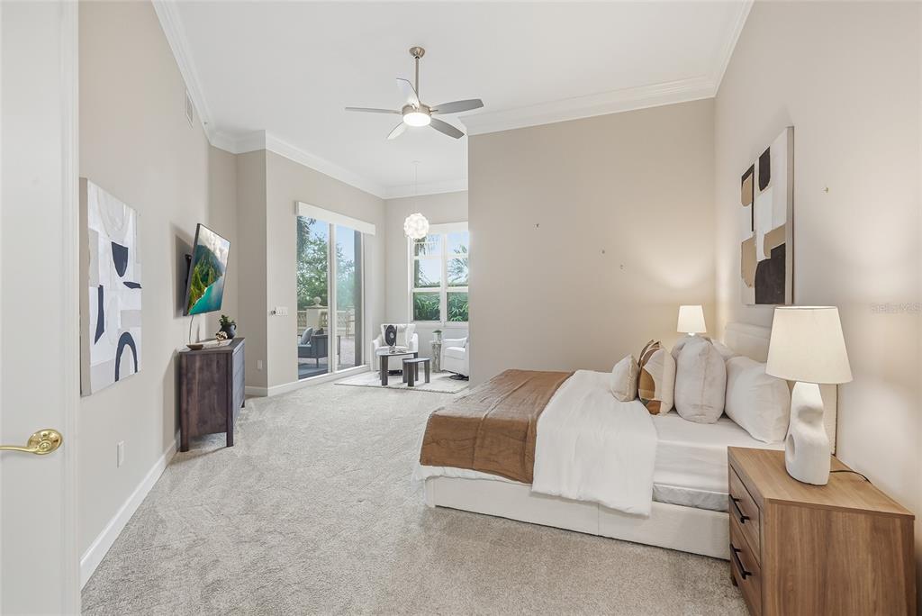 A spacious bedroom features a king bed, neutral carpeting, a ceiling fan, and a balcony — 100 BEACH DRIVE NE UNIT 301, ST PETERSBURG, FL