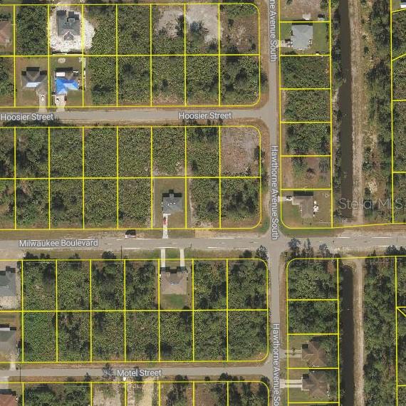 This is an aerial map showing residential lots and streets in a neighborhood — 881 MILWAUKEE BOULEVARD, LEHIGH ACRES, FL