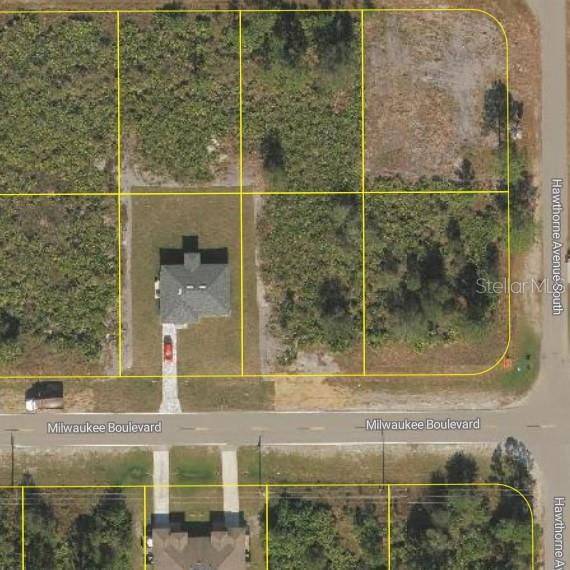 This aerial map shows a residential lot with a house and surrounding vacant land — 881 MILWAUKEE BOULEVARD, LEHIGH ACRES, FL