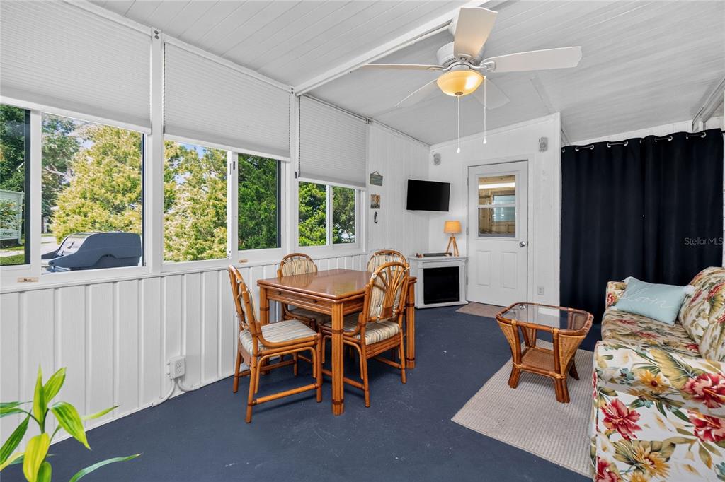 A sunroom features a dining set, a floral sofa, and a ceiling fan — 6741 LAUREL COURT, NORTH PORT, FL