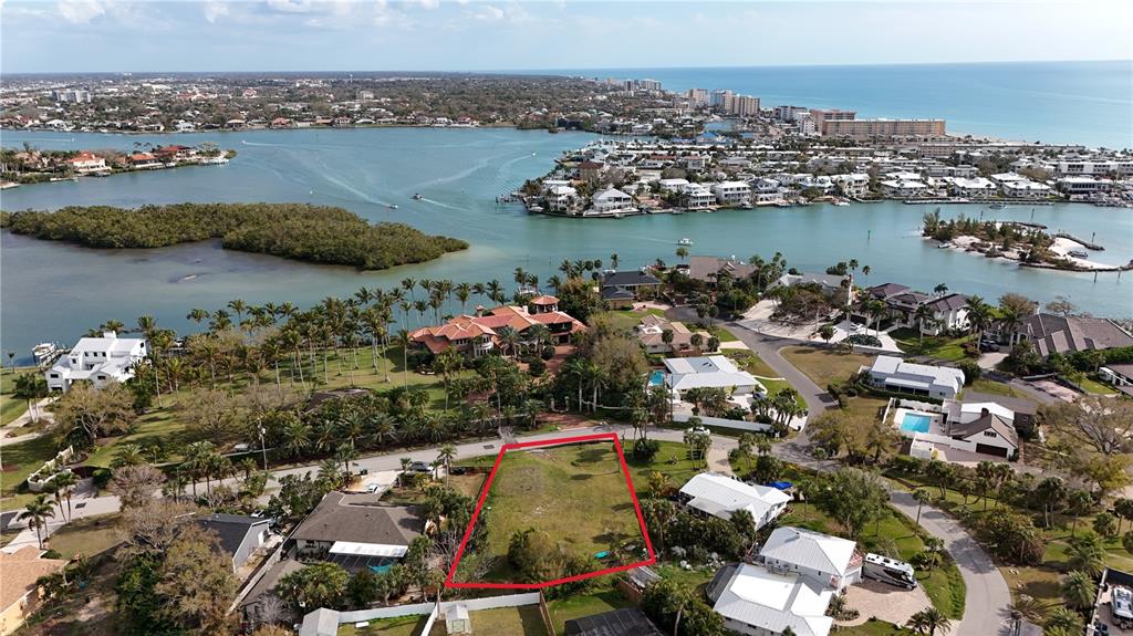 An aerial view shows a vacant, rectangular residential lot outlined in red near the water — 514 BAYVIEW PARKWAY, NOKOMIS, FL