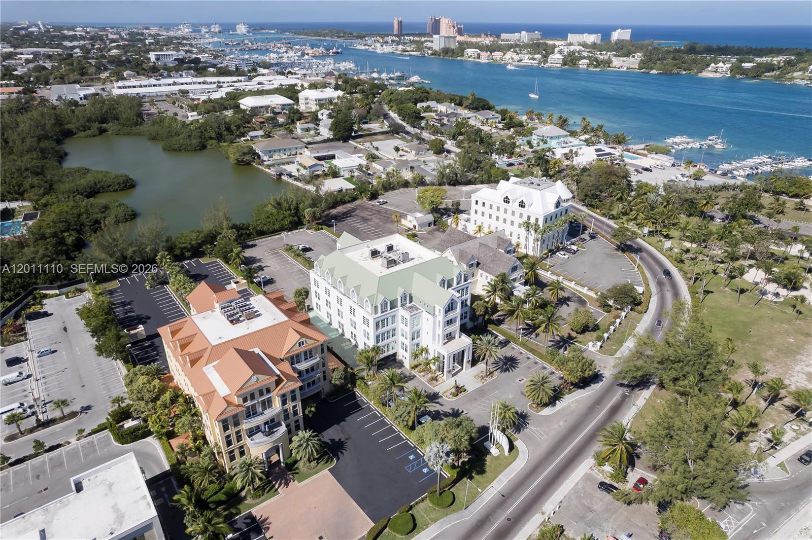An aerial view shows three large office buildings surrounded by parking lots and tropical landscaping — 9 E Bay Street, 00000, FL
