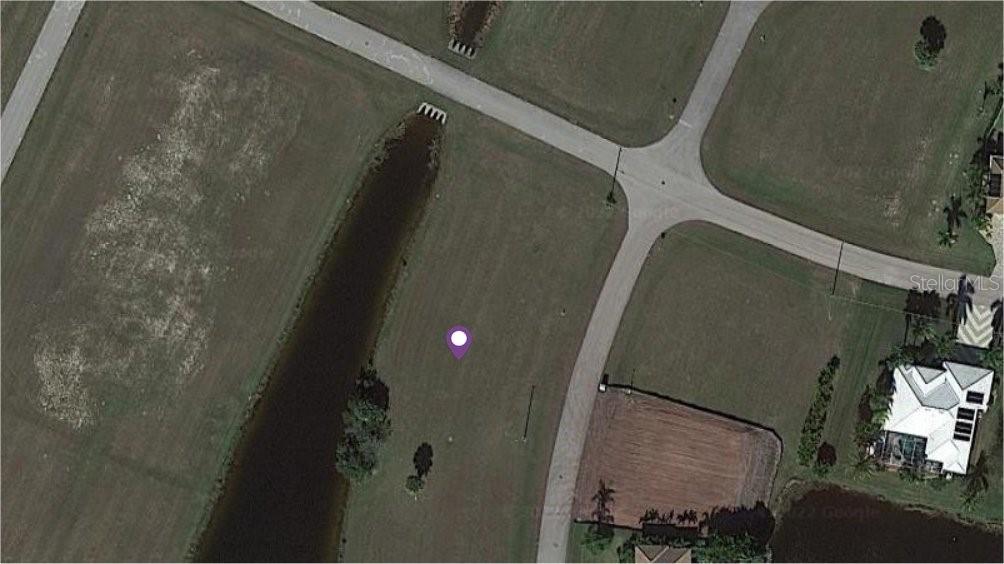 This is an aerial map view of a vacant residential lot next to a canal — 17475 BELIE WAY, PUNTA GORDA, FL