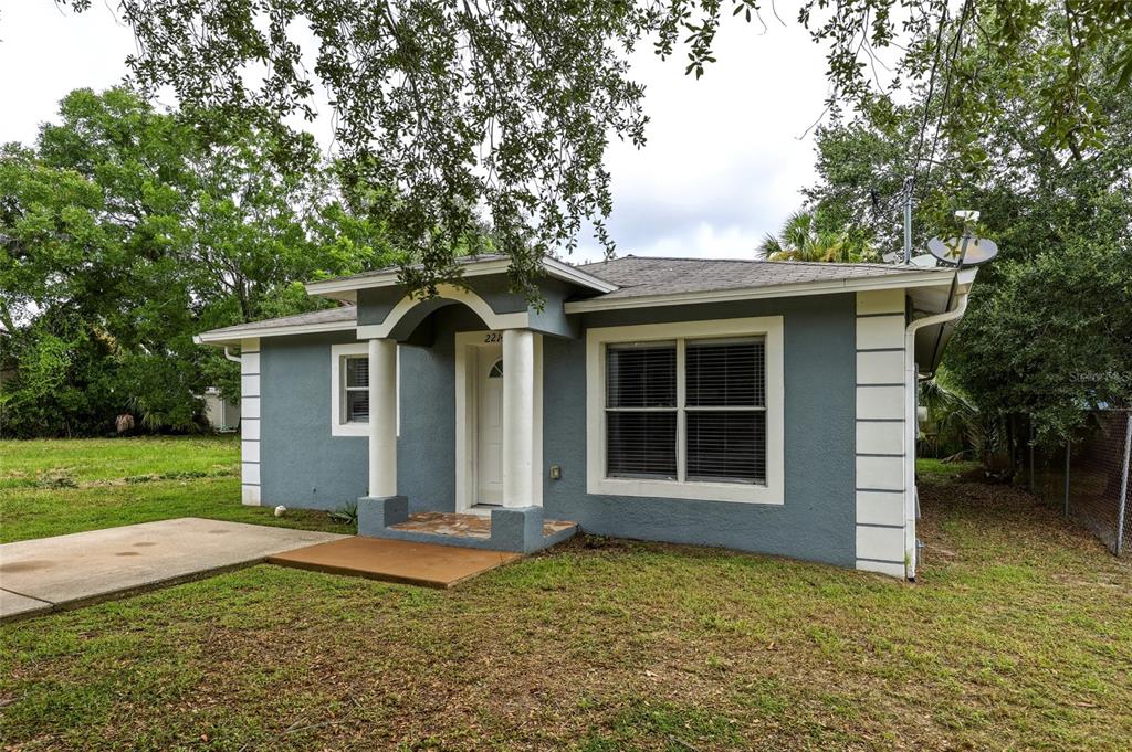 A gray, single-story house with a covered front porch, white columns, and a concrete driveway — 2214 E 19TH AVENUE, TAMPA, FL