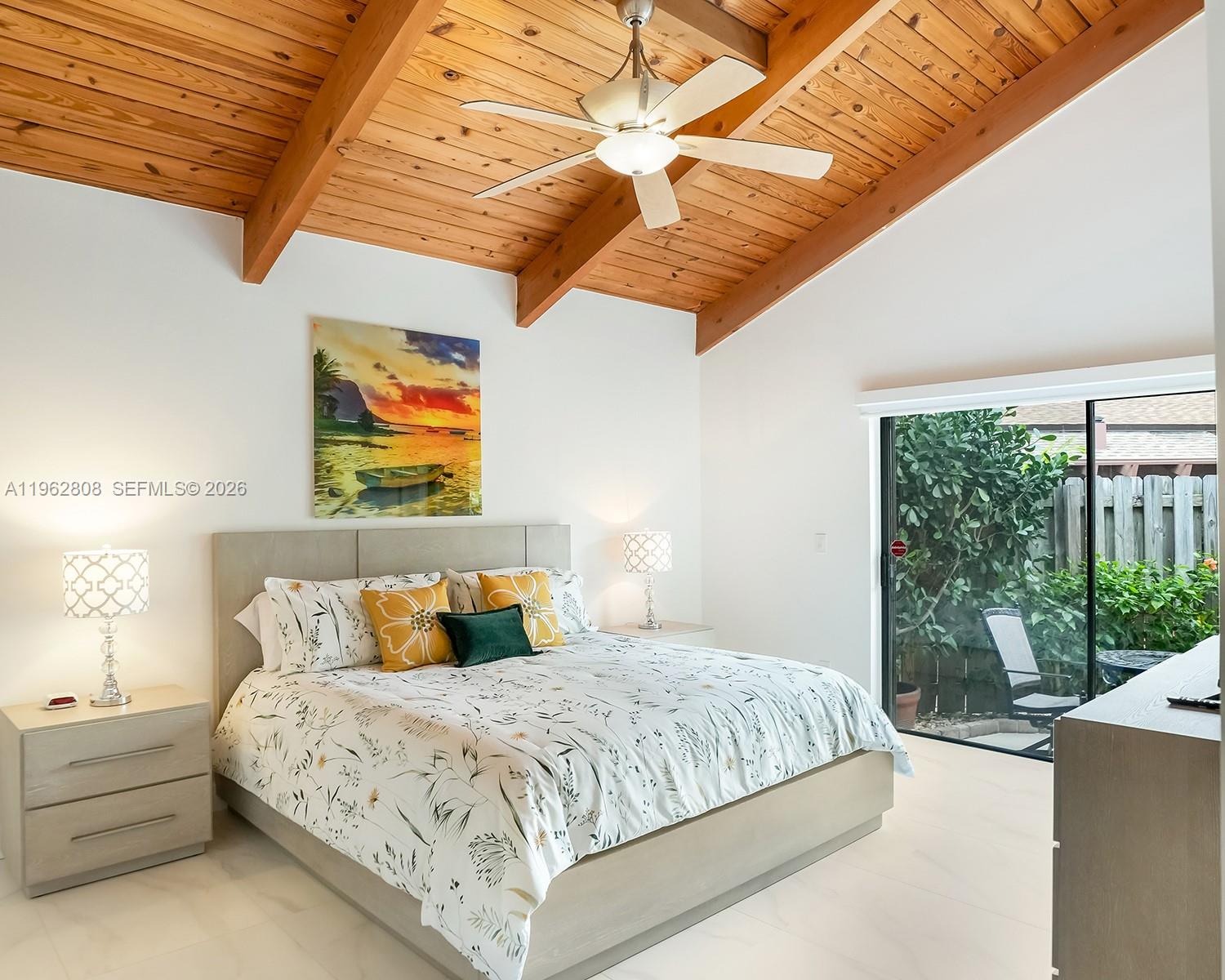 A bedroom features a vaulted wood-plank ceiling, a ceiling fan, and a sliding glass door — 413 Leslie Dr, Hallandale Beach FL 33009, HALLANDALE BEACH, FL