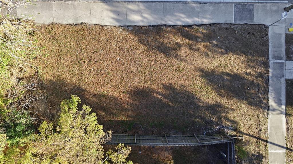 An aerial view shows a vacant, rectangular residential lot bordered by sidewalks and trees — 2616 N 19TH STREET, TAMPA, FL