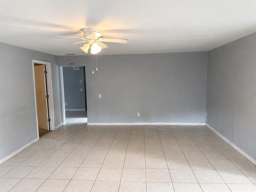 A room with gray walls, a ceiling fan, and light-colored tile flooring — 1519 LYNN AVENUE, CLEARWATER, FL