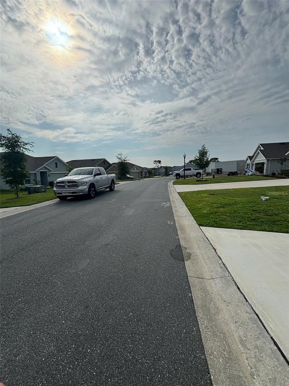 A residential street features a silver pickup truck parked on the side of the road — 361 W FAIRWAYS VIEW DRIVE, BEVERLY HILLS, FL