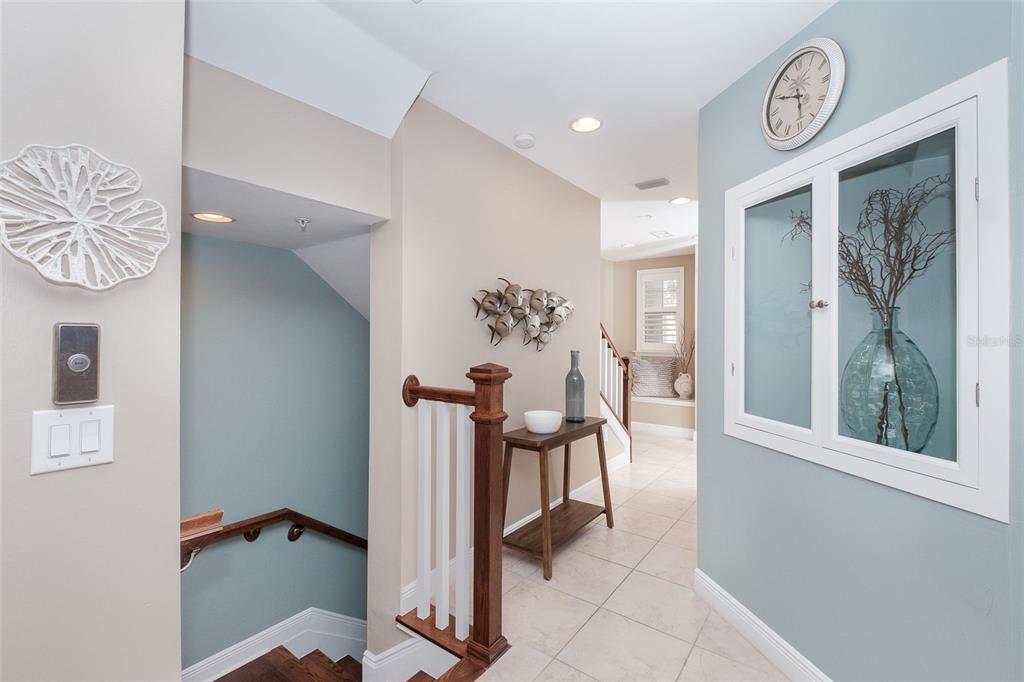 A blue-walled entryway features a white door, tiled floor, and stairs with wooden treads — 10330 LONGSHORE ROAD UNIT 51, PLACIDA, FL