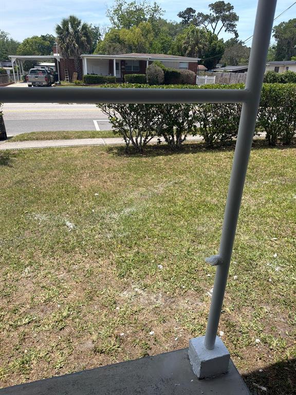 A view from a porch looking across a lawn toward a single-story residential house — 3761 JAMMES ROAD, JACKSONVILLE, FL