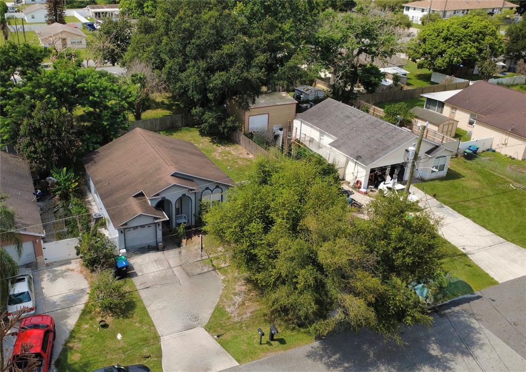 An aerial view shows two suburban houses with driveways, trees, and a detached garage — 310 PRINCE STREET, ORLANDO, FL