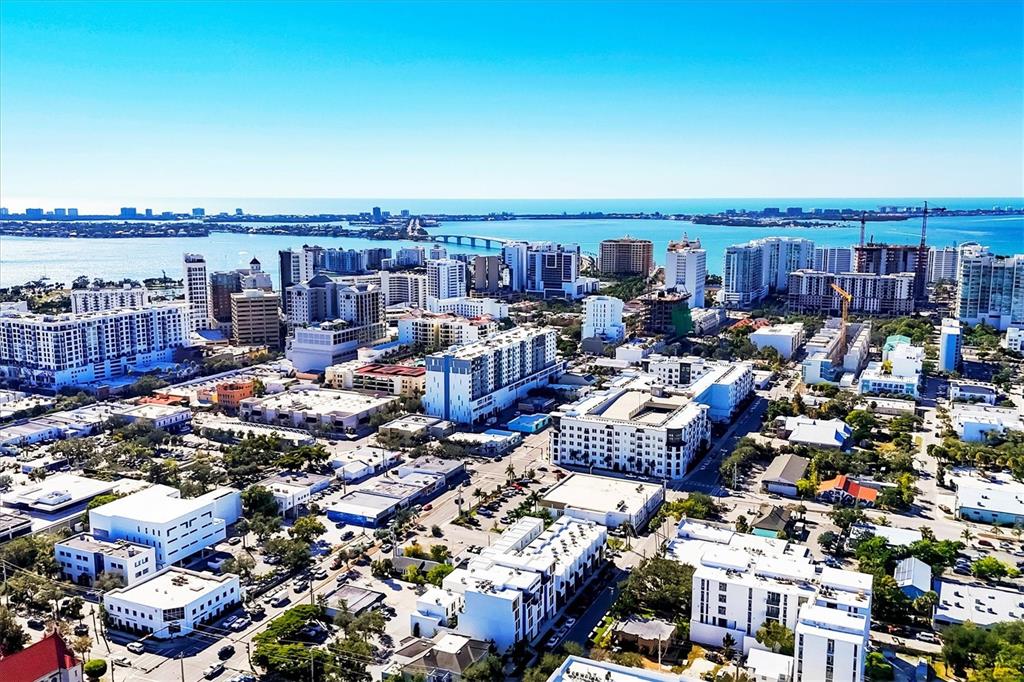 An aerial view of a coastal city with numerous mid-rise buildings and a bridge — 1558 4TH STREET UNIT 216, SARASOTA, FL