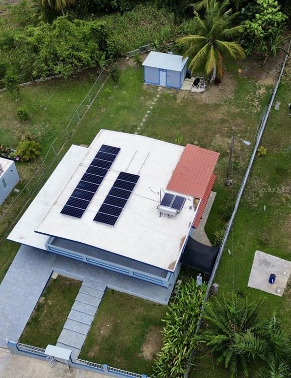An aerial view shows a house with solar panels and a solar water heater on top — Bo Quebrada Fajardo CARR#985 KM 1.3 Lote#5, FAJARDO, PR