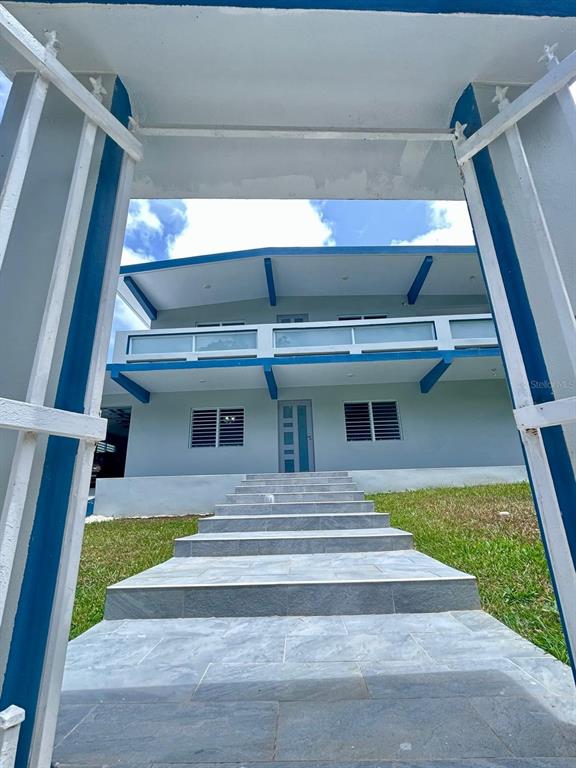A two-story house with a blue-trimmed balcony and stairs leading to the front entrance — Bo Quebrada Fajardo CARR#985 KM 1.3 Lote#5, FAJARDO, PR