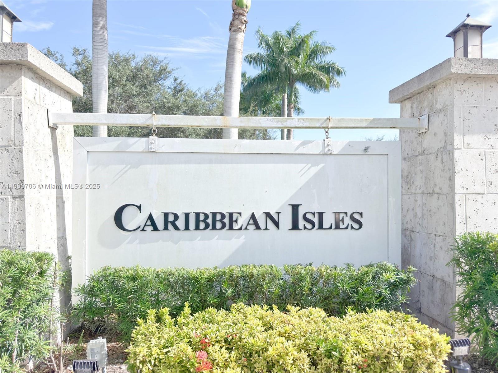 A white sign with the text Caribbean Isles stands between two stone pillars — 2610 NE 3rd Dr # 203, Homestead FL 33033, HOMESTEAD, FL