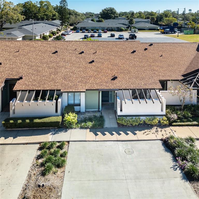 An aerial view shows the exterior of a single-story townhouse with a brown shingled roof — 2383 SUN VALLEY CIRCLE UNIT 2383, WINTER PARK, FL