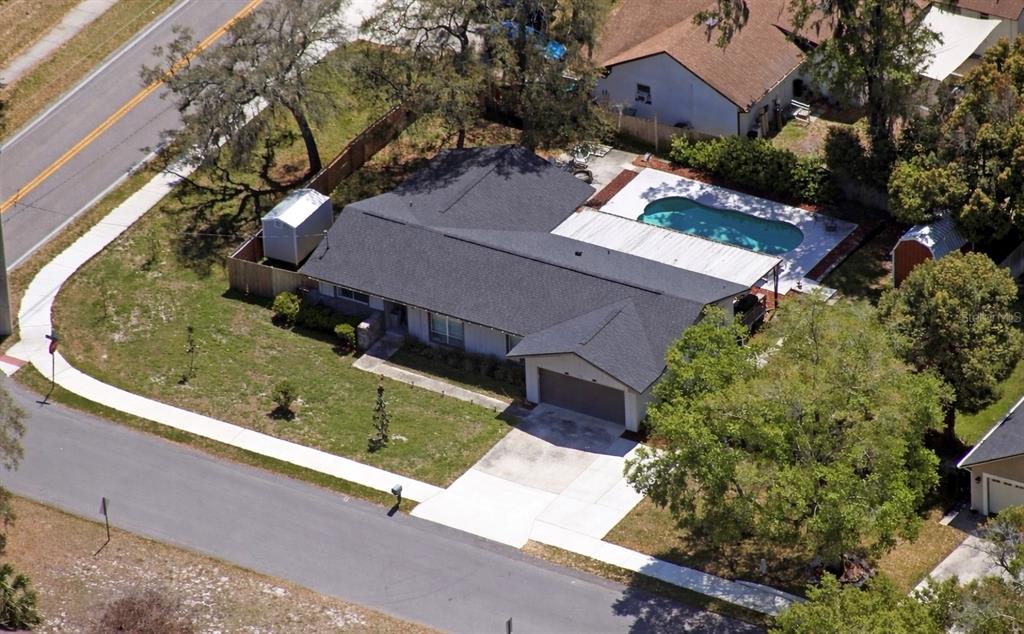 An aerial view of a single-story house with a dark roof, pool, and attached garage — 2746 MENDELIN STREET, APOPKA, FL