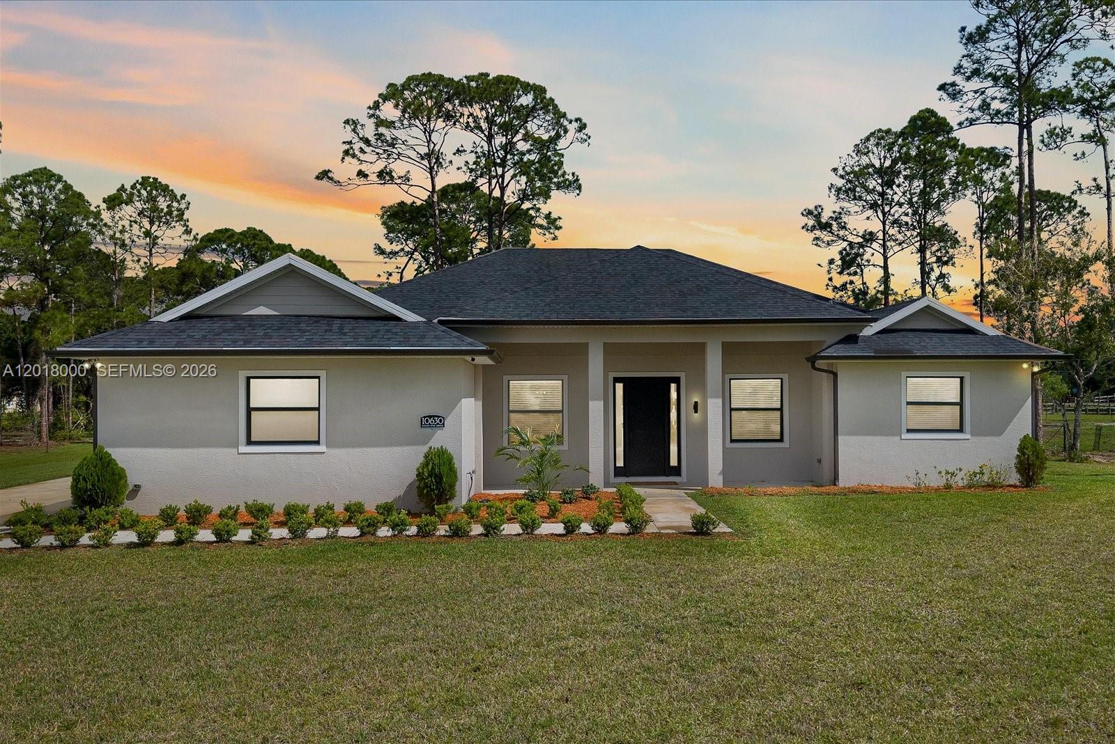 A single-story house with a gray exterior, dark roof, and a front walkway — 10630 Sugar Pine Dr, Fort Pierce FL 34945, FORT PIERCE, FL