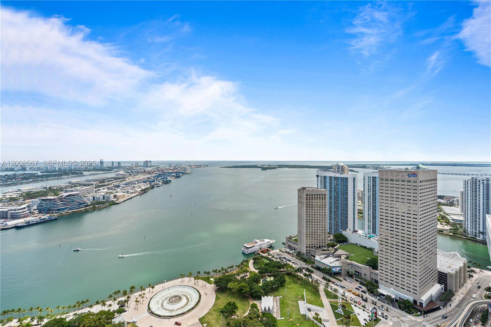 An aerial view of a waterfront park, city skyline, and harbor under a blue sky — 50 Biscayne Blvd # 5402, Miami FL 33132, MIAMI, FL