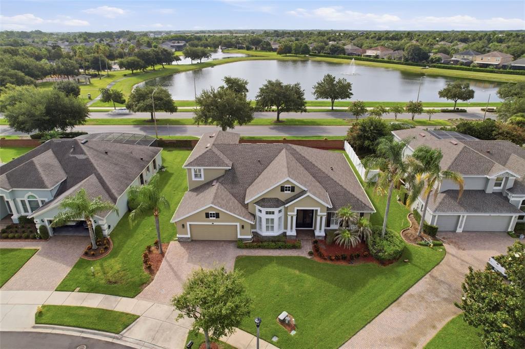An aerial view shows a suburban house with a shingled roof and a pond nearby — 426 DUFF DRIVE, WINTER GARDEN, FL