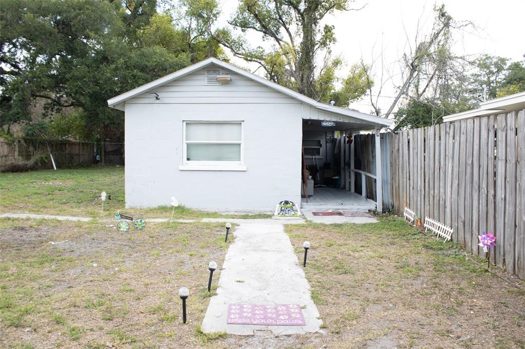 A small, light-colored house with a concrete walkway leading to a covered front porch — 621 W SOUTH STREET, ORLANDO, FL