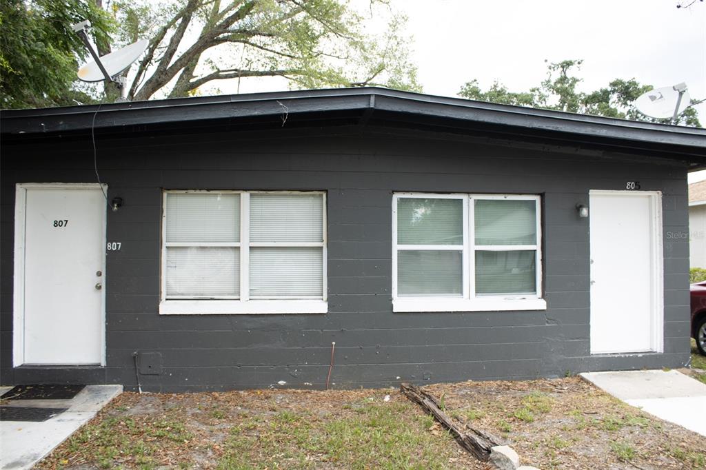 The exterior of a dark gray building features two white doors and two windows — 621 W SOUTH STREET, ORLANDO, FL