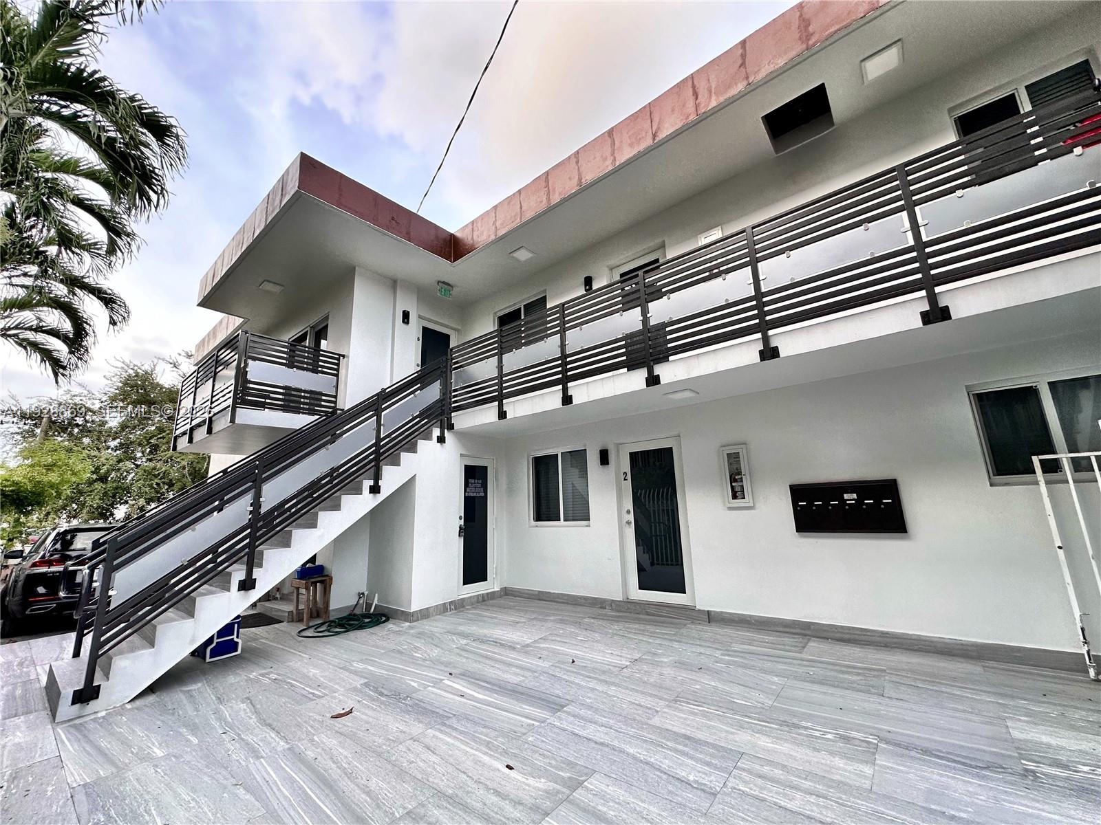 An exterior view of a two-story apartment building with a staircase and metal railings — 1629 SW 3rd St # 5, Miami FL 33135, MIAMI, FL