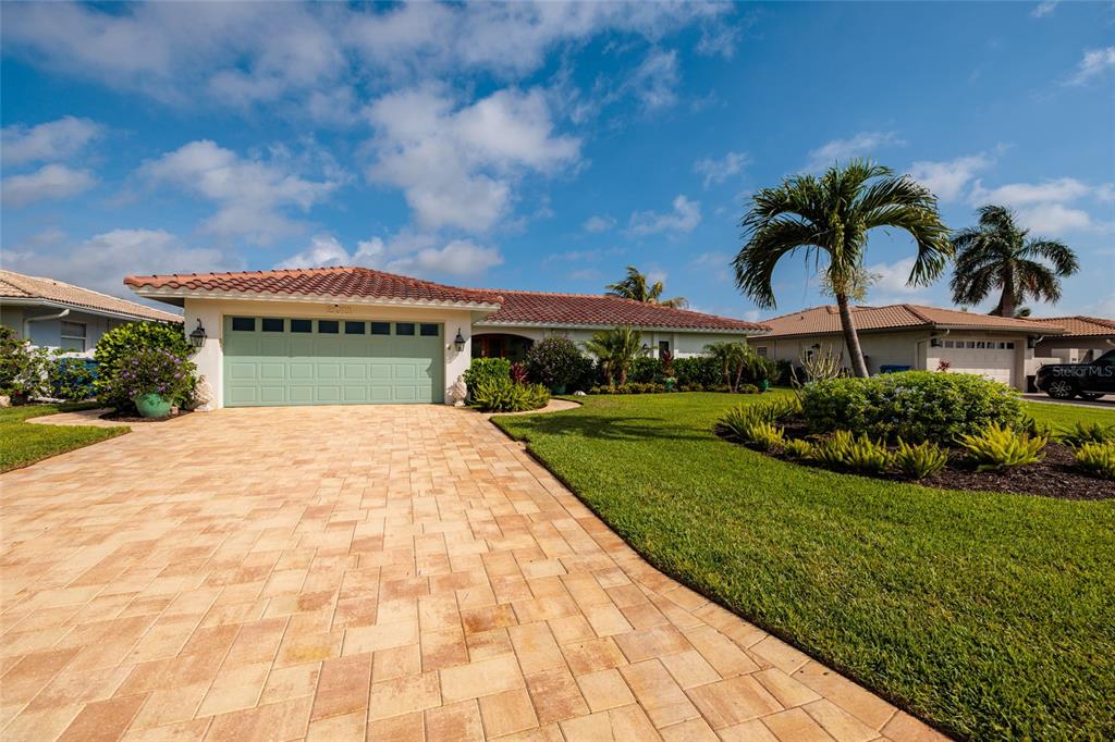 A single-story house with a light green garage door and a paved driveway — 2011 MICHIGAN AVENUE NE, ST PETERSBURG, FL