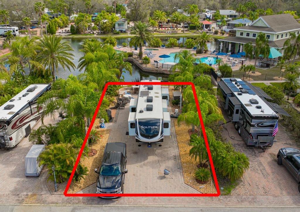 An aerial view shows a paved RV lot featuring a Solitude fifth-wheel trailer and truck — 6770 AMANDA VISTA CIRCLE, LAND O LAKES, FL